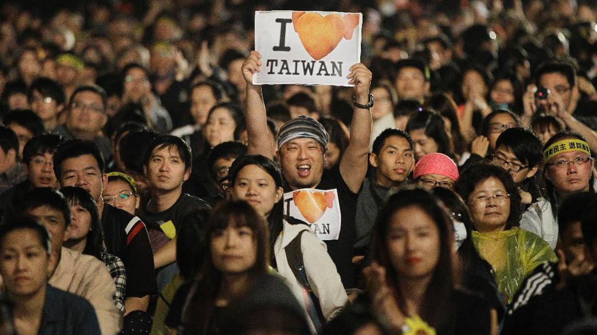 Taiwanese demonstrators celebrate outside the Taiwan presidential building