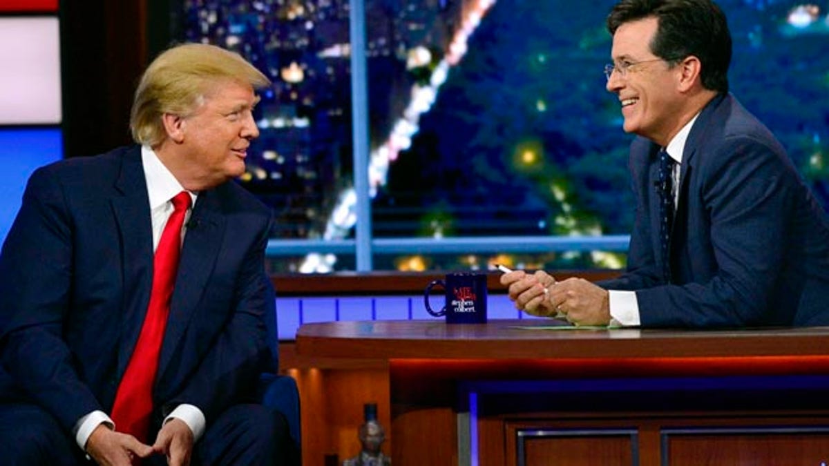 In this photo provided by CBS, Republican presidential candidate Donald Trump, left, joins host Stephen Colbert on the set of 'The Late Show with Stephen Colbert' in New York. (John Paul Filo/CBS via AP)