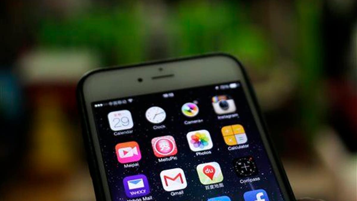 A Gmail mobile app, center left, is seen on a smartphone in Beijing.