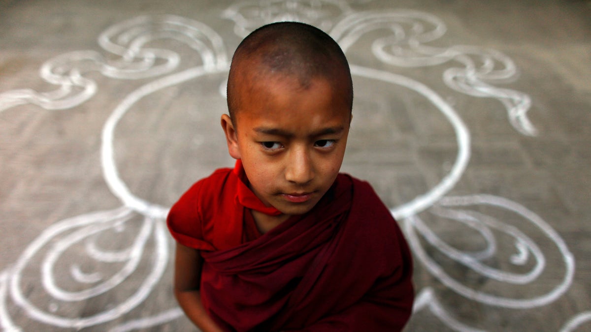 A Tibetan monk stands at a Tibetan Monastery during the third day of 