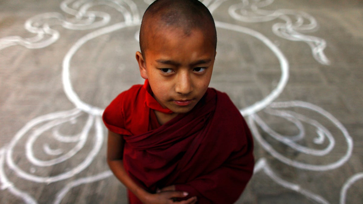 A Tibetan monk stands at a Tibetan Monastery during the third day of