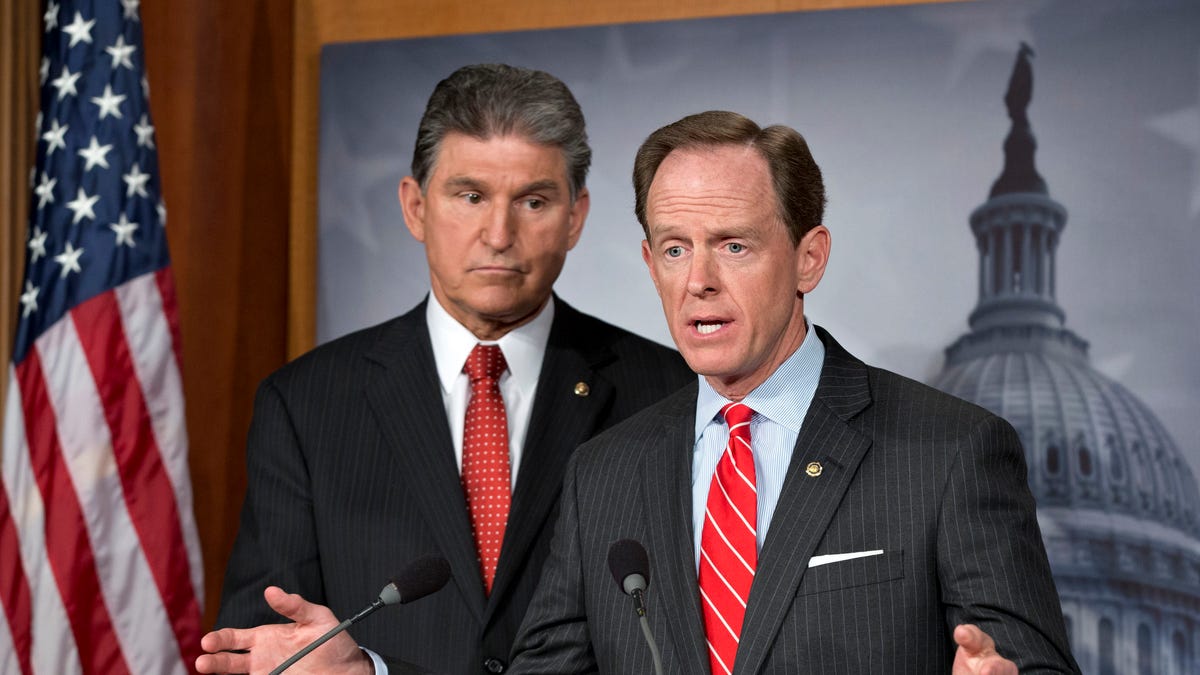 FILE: April 10, 2013: Sen. Joe Manchin, D-W.V., left, and Patrick Toomey, R-Pa., announce a deal on gun-control legislation, on Capitol Hill, in Washington, D.C.