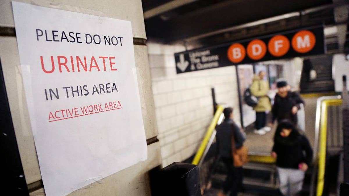 A sign hangs in the West 4th Street subway station reads 