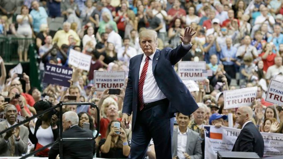 Donald Trump waves to supporters after speaking at a campaign event in Dallas, Monday, Sept. 14, 2015. (AP Photo/LM Otero)