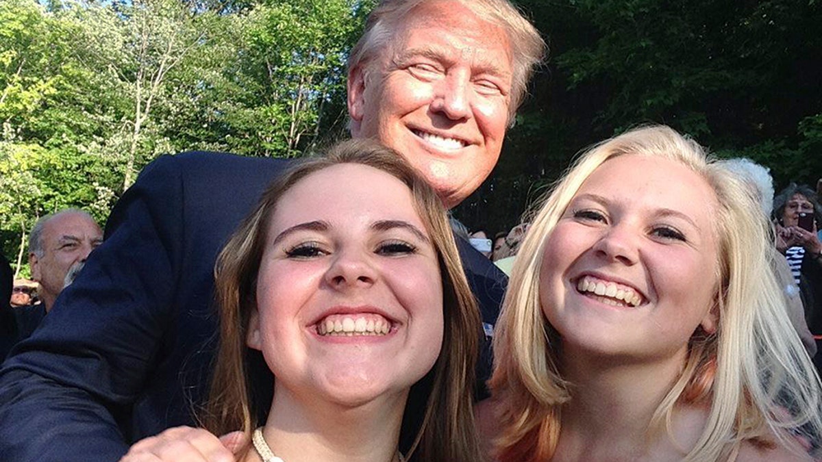 Trump poses with Emma Nozell (left) and her sister Addy in July 17 2015