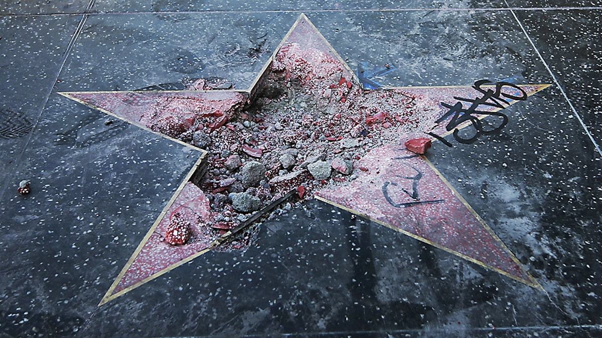his Wednesday, July 25, 2018 file photo shows Donald Trump's vandalized star on the Hollywood Walk of Fame in Los Angeles.