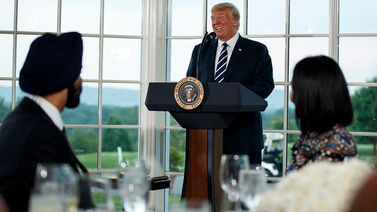 7876715f-President Donald Trump speaks at a dinner meeting with business leaders, Tuesday, Aug. 7, 2018, at Trump National Golf Club in Bedminster, N.J.