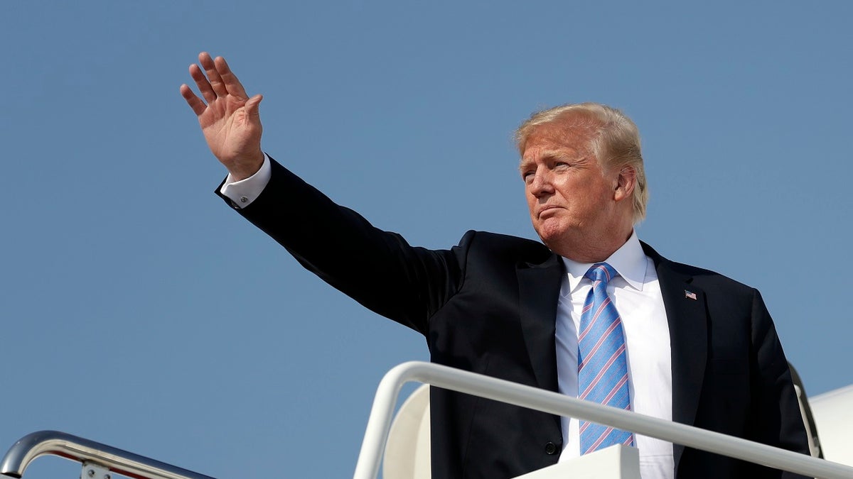 FILE - In this July 3, 2018 file photo President Donald Trump waves as he boards Air Force One at Andrews Air Force Base, Md. U.S. Sen. Jon Tester is giving Trump a tongue-in-cheek welcome to Montana by taking out a full-page ad in 14 newspapers thanking the president for signing 16 bills that the Democrat sponsored or co-sponsored. Trump was scheduled to hold a rally Thursday, July 5, 2018, in Great Falls to campaign for Tester's Republican challenger, State Auditor Matt Rosendale. The president has made the Montana Senate race a priority after he blamed Tester for derailing the nomination of his first Veterans Affairs nominee, White House physician Ronny Jackson. (AP Photo/Evan Vucci, File)