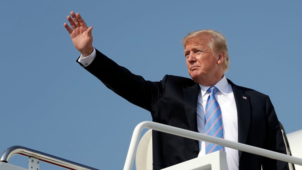 FILE - In this July 3, 2018 file photo President Donald Trump waves as he boards Air Force One at Andrews Air Force Base, Md. U.S. Sen. Jon Tester is giving Trump a tongue-in-cheek welcome to Montana by taking out a full-page ad in 14 newspapers thanking the president for signing 16 bills that the Democrat sponsored or co-sponsored. Trump was scheduled to hold a rally Thursday, July 5, 2018, in Great Falls to campaign for Tester's Republican challenger, State Auditor Matt Rosendale. The president has made the Montana Senate race a priority after he blamed Tester for derailing the nomination of his first Veterans Affairs nominee, White House physician Ronny Jackson. (AP Photo/Evan Vucci, File)