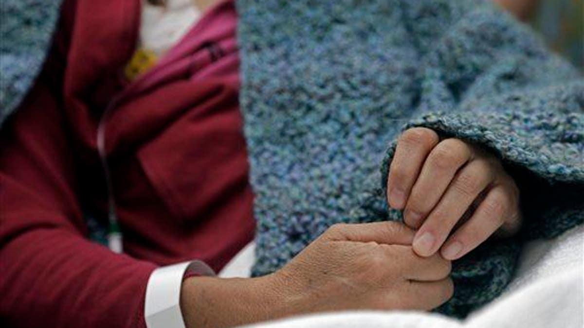 A woman undergoes chemotherapy treatment at a cancer center.