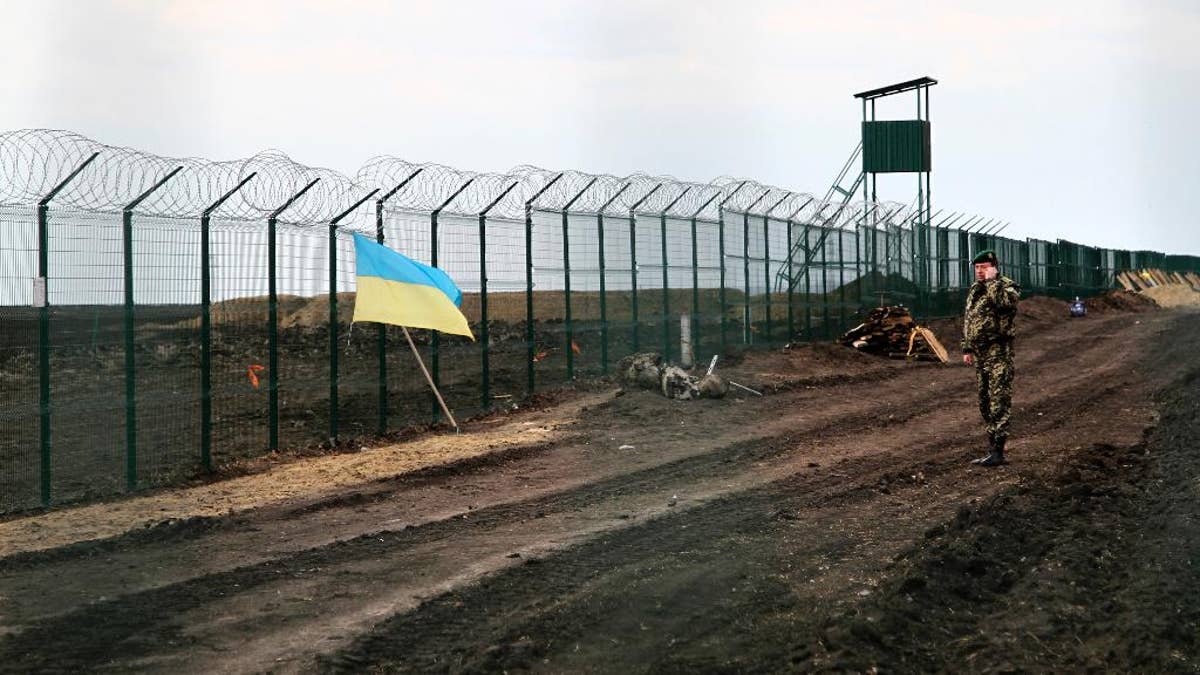 As Ukraine erects defensive fence on Russian border, critics fear
