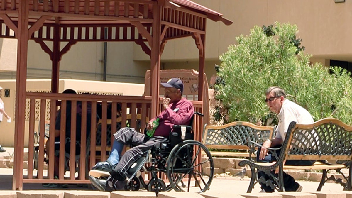 July 3, 2014: Men sit outside the Raymond G. Murphy VA Medical Center in Albuquerque, N.M..