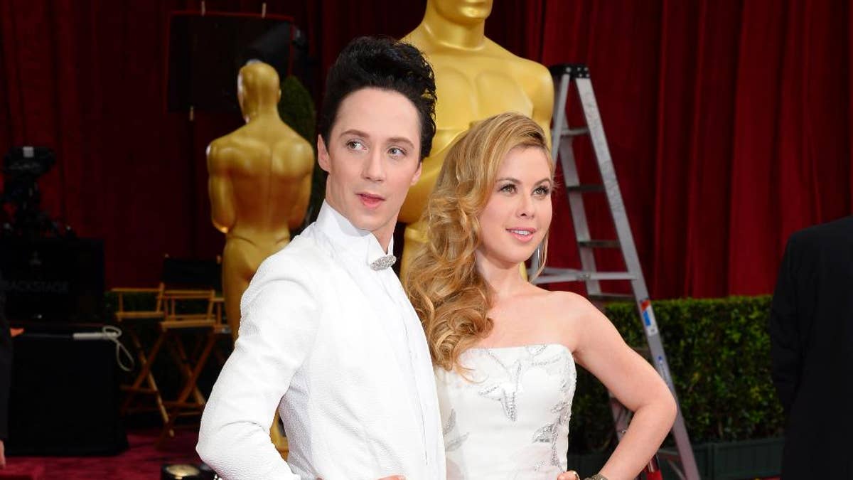 FILE - This March 2, 2014, file photo shows Johnny Weir, left, and Tara Lipinski at the Oscars in Los Angeles. NBC is promoting Weir and Lipinski to its top figure skating broadcasting team. The network said Wednesday, Oct. 22, 2014,  that the two former Olympians and play-by-play announcer Terry Gannon will take over the role starting with this week's Skate America.  (Photo by Dan Steinberg/Invision/AP, File)