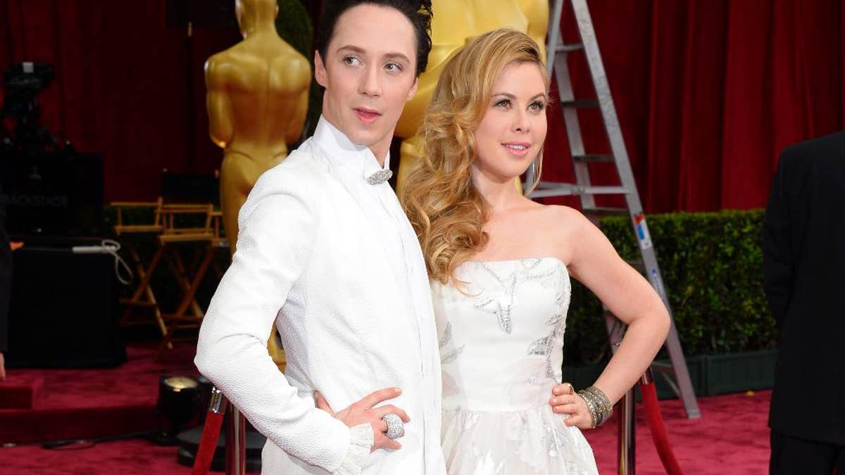 FILE - This March 2, 2014, file photo shows Johnny Weir, left, and Tara Lipinski at the Oscars in Los Angeles. NBC is promoting Weir and Lipinski to its top figure skating broadcasting team. The network said Wednesday, Oct. 22, 2014,  that the two former Olympians and play-by-play announcer Terry Gannon will take over the role starting with this week's Skate America.  (Photo by Dan Steinberg/Invision/AP, File)