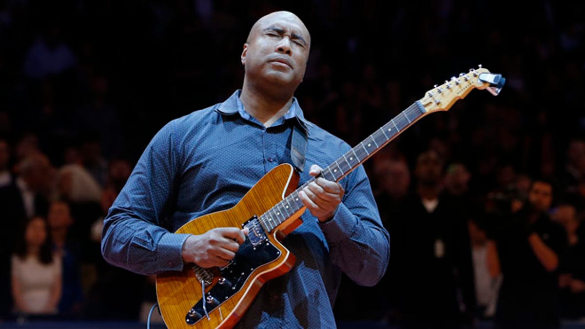 FILe - In this Feb. 1, 2014, file photo, former New York Yankee baseball player Bernie Williams plays the nation anthem on a guitar before an NBA basketball game between the Miami Heat and the New York Knicks, in New York. Williams stopped being a baseball player in 2006. Since age 7, he hasnât stopped being a musician. His father brought a guitar back from a trip to Spain while serving in the Merchant Marines, and Williams fell in love with music after learning the first few chords. (AP Photo/Jason DeCrow, File)