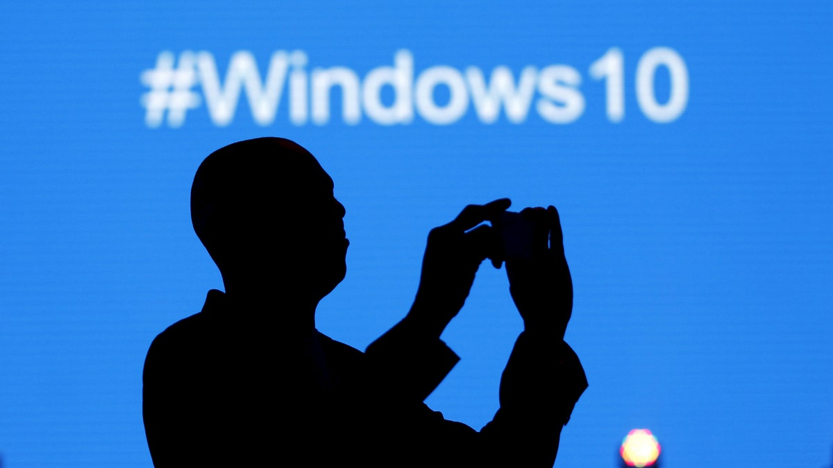 File photo - A Microsoft delegate takes a picture during the launch of the Windows 10 operating system in Kenya's capital Nairobi, July 29, 2015. 