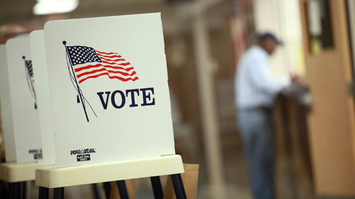 WATERLOO, IA - SEPTEMBER 27: Voting booths are set up for early voting at the Black Hawk County Courthouse on September 27, 2012 in Waterloo, Iowa. Early voting starts today in Iowa where in the 2008 election 36 percent of voters cast an early ballot.  (Photo by Scott Olson/Getty Images)