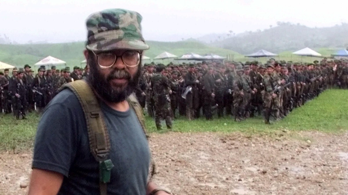 FILE - In this April 28, 2000 file photo, Alfonso Cano, a Revolutionary Armed Forces of Colombia (FARC) commander who will head the Boliviarian Movement, a new clandestine political party for the rebels, attends a practice ceremony for the political party opening outside of San Vicente del Caguan in the FARC controlled zone of Colombia. According to Colombian military authorities, Cano, the top FARC commander, was killed in a military operation on Friday Nov. 4, 2011. (AP Photo/Scott Dalton, File)