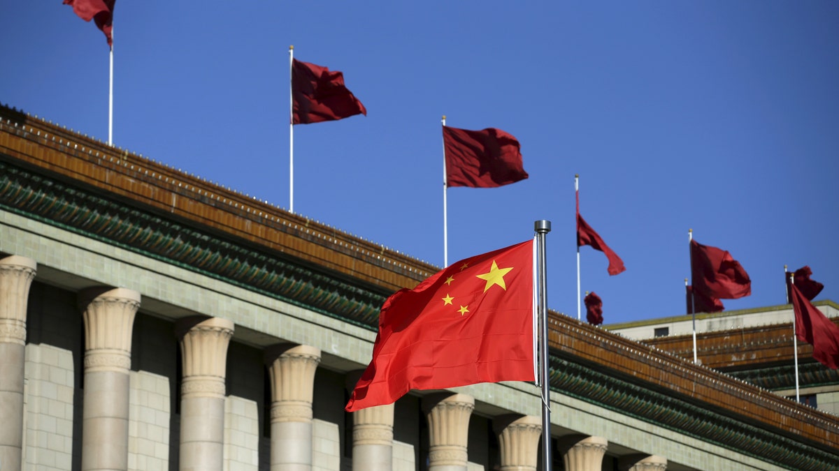 Chinese flag waves in front of the Great Hall of the People in Beijing, China, October 29, 2015. If China's yuan joins the International Monetary Fund's benchmark currency basket, changes in its economy will likely be felt more deeply in Asian financial markets, a senior IMF official said on Wednesday. REUTERS/Jason Lee - RTX1TQMN