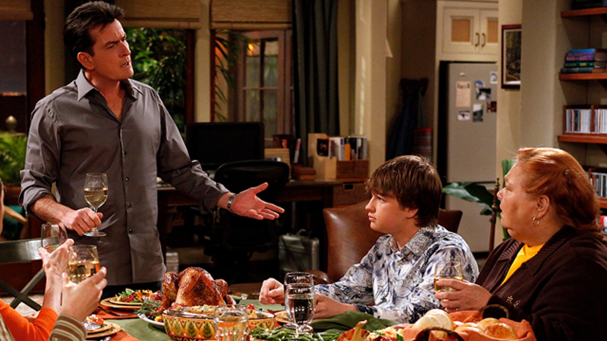 In this undated publicity image released by CBS, from left, Charlie Sheen, Angus T. Jones and Conchata Ferrell are shown during the taping of 