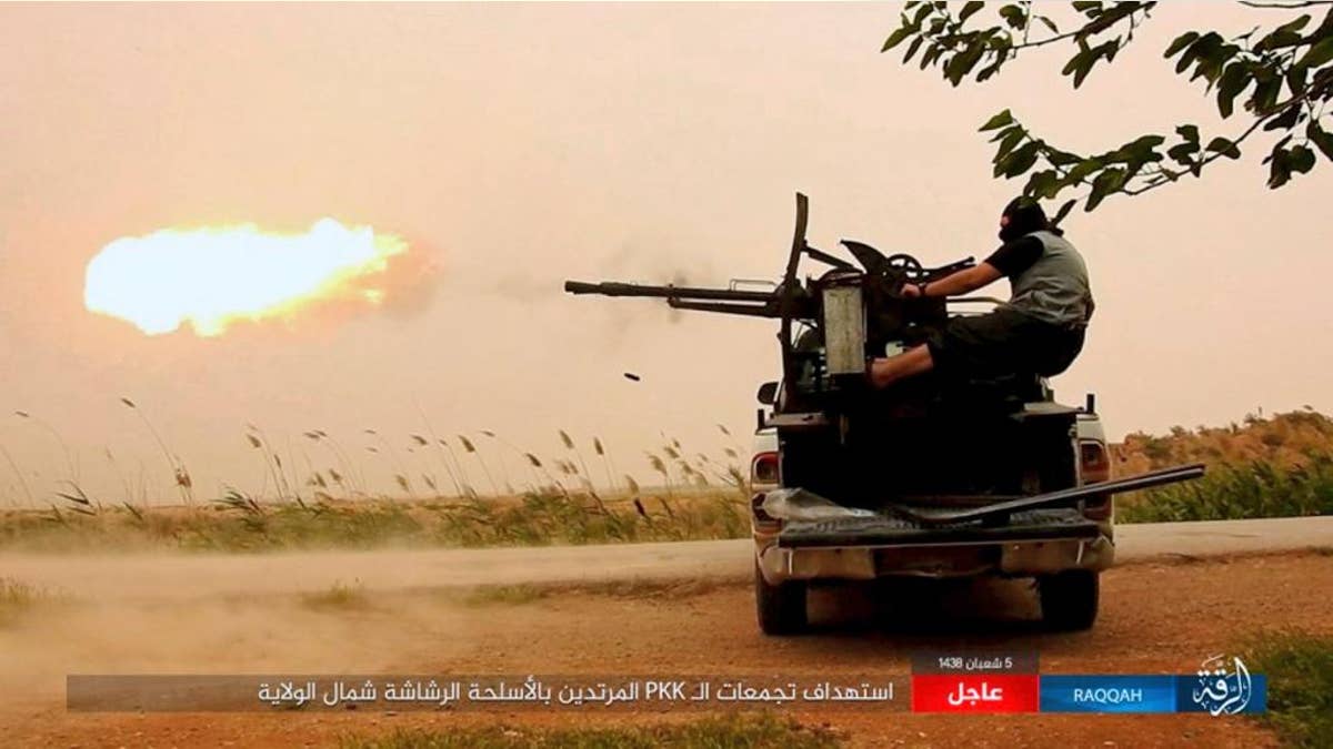 An ISIS fighter firing his weapon in Raqqa, Syria.