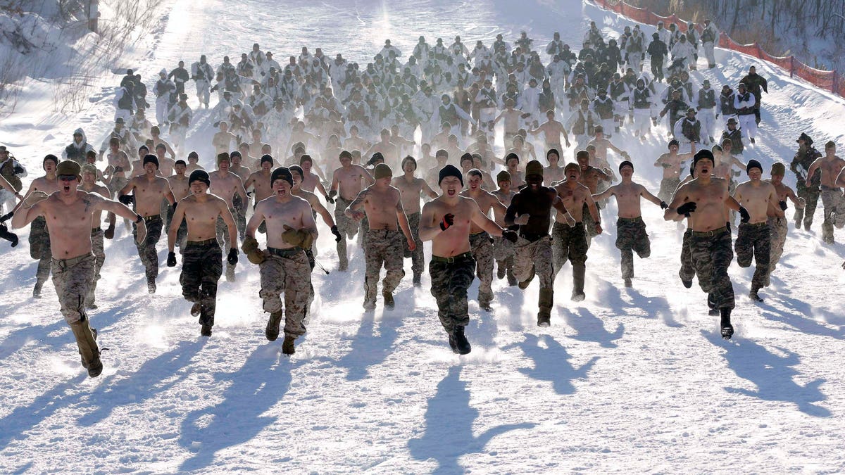 Shirtless South Korean Marines and their U.S. counterparts from 3-Marine Expeditionary Force 1st Battalion from Kaneho Bay, Hawaii, run on a snow covered field during their Feb. 4-22 joint military winter exercise in Pyeongchang, east of Seoul, South Korea, Thursday, Feb. 7, 2013. More than 400 marines from the two countries participated in the joint winter exercise held for the first time in South Koreas. (AP Photo/Lee Jin-man)