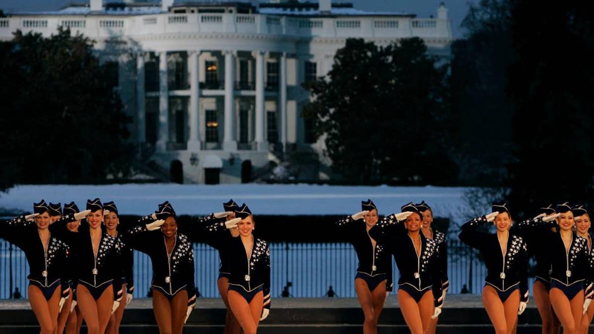 FILE - In this Wednesday, Jan. 19, 2005, file photo, the Rockettes perform during the Celebration of Freedom Concert on the Ellipse, with the White House in the background in Washington. The Radio City Rockettes have been assigned to dance at President-elect Donald Trump’s inauguration January 2017. (AP Photo/Chris Gardner, File)