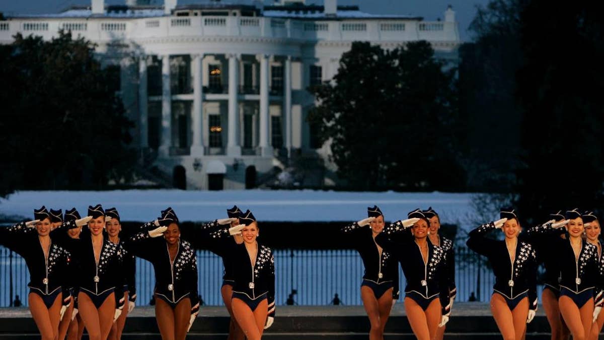 FILE - In this Wednesday, Jan. 19, 2005, file photo, the Rockettes perform during the Celebration of Freedom Concert on the Ellipse, with the White House in the background in Washington. The Radio City Rockettes have been assigned to dance at President-elect Donald Trump’s inauguration January 2017. (AP Photo/Chris Gardner, File)