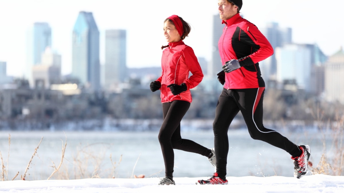 a7a08bb5-Runners running in winter city