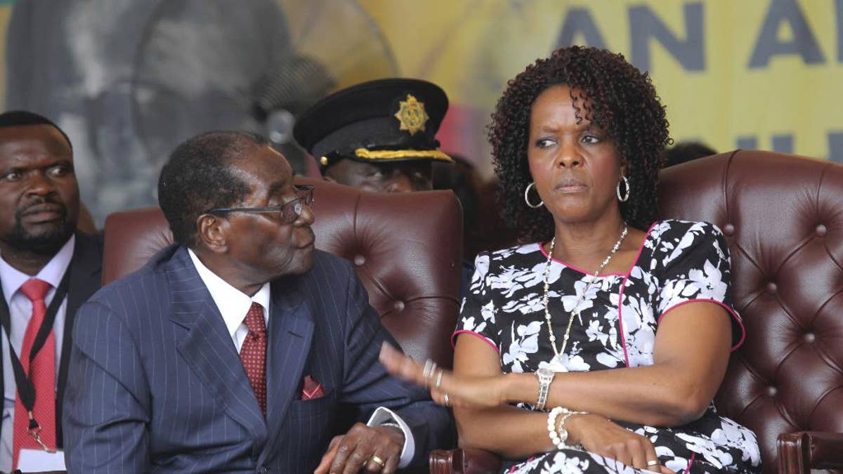 FILE - Zimbabwean President Robert Mugabe and his wife Grace are seen during his birthday celebrations in Masvingo in this Saturday, Feb, 27, 2016 file photo. Zimbabwean President Robert Mugabe plucked her from the secretarial pool decades ago to become his wife, and now Grace Mugabe is stirring speculation that she wants to succeed her 93-year-old husband as leader.(AP Photo/Tsvangirayi Mukwazhi, FILE)