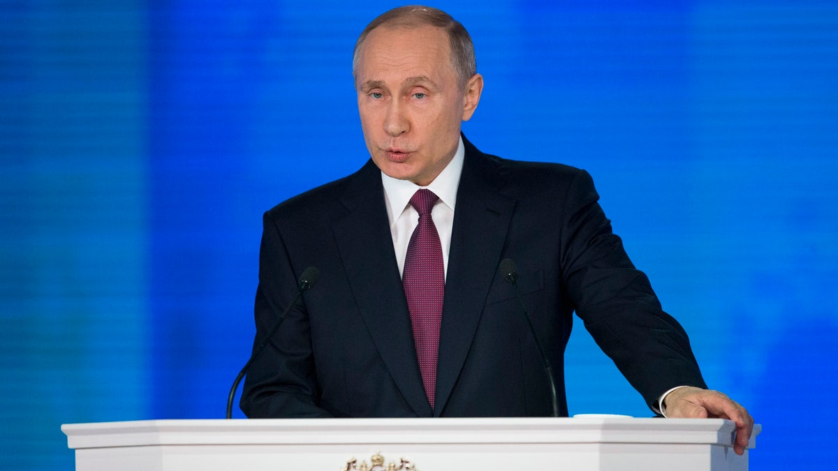 Russian President Vladimir Putin gives his annual state of the nation address in Manezh in Moscow, Russia, Thursday, March 1, 2018. President Vladimir Putin set a slew of ambitious economic goals, vowing to boost living standards, improve health care and education and build modern infrastructure in a state-of-the-nation address. (AP Photo/Alexander Zemlianichenko)