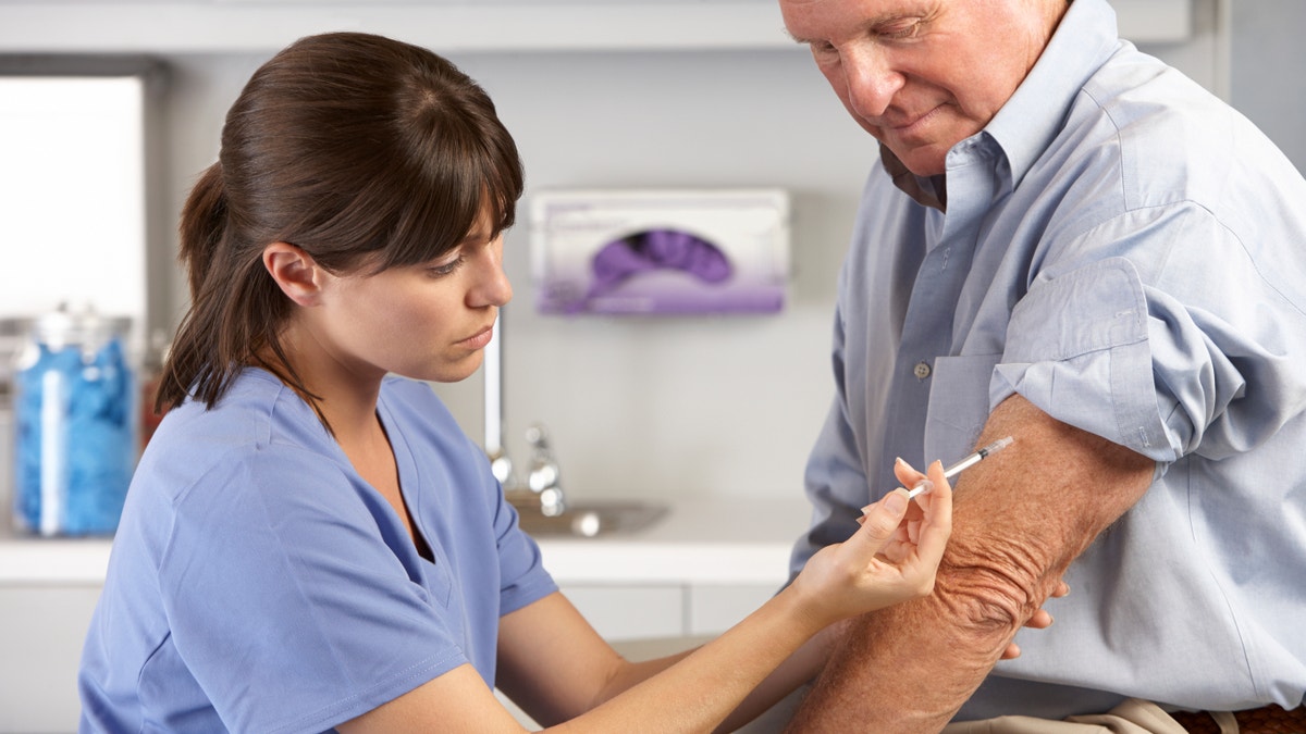 adult man getting vaccinated istock