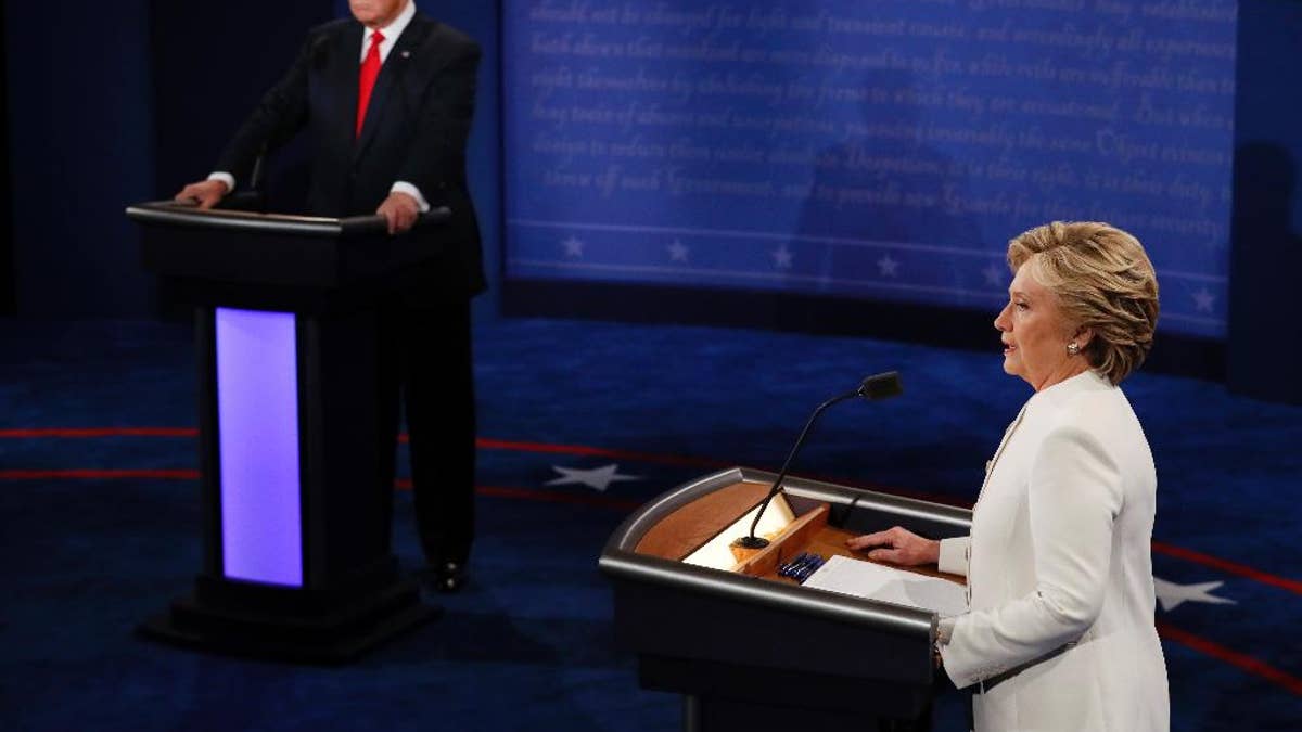 Democratic presidential nominee Hillary Clinton speaks as Republican presidential nominee Donald Trump listens during the third presidential debate at UNLV in Las Vegas, Wednesday, Oct. 19, 2016. (Mark Ralston/Pool via AP)