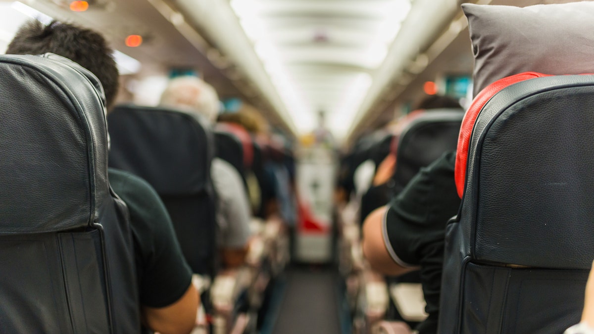 airplane cabin passengers istock medium