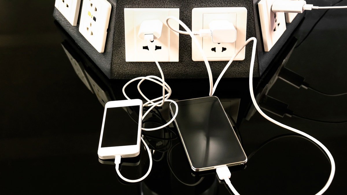 Charging station for mobile smart phones at international airport  - Helpful corner for electronical modern technology devices and smartphones