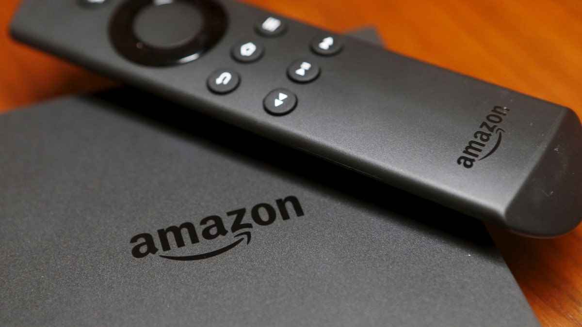 The new Amazon Fire TV is displayed during a media event introducing new Amazon products in San Francisco, California September 16, 2015. Amazon on Thursday rolled out a line of tablets and revamped Fire TV gadgets. The $99.99 Fire TV set-top box integrates its cloud-based virtual assistant Alexa, allowing viewers to check the weather, look up sports scores and play music. Photo taken September 16, 2015.  REUTERS/Beck Diefenbach - RTS1KUO