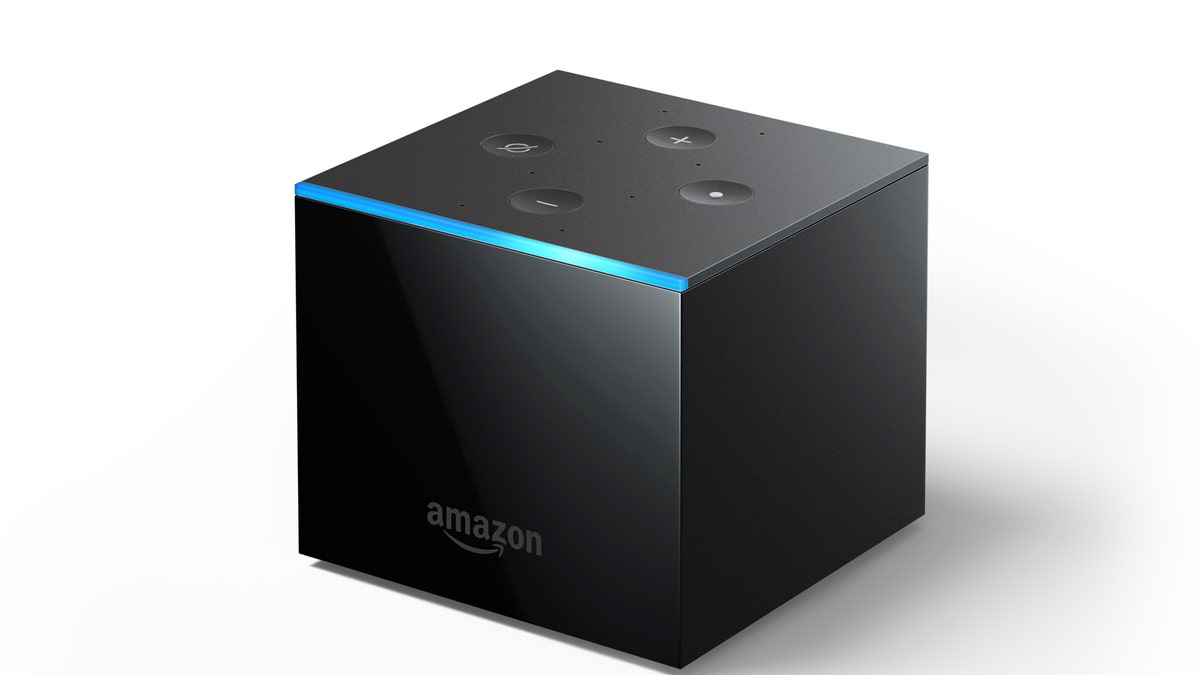 This undated image provided by Amazon.com, Inc. shows an Amazon Fire TV Cube. Amazon unveiled the new voice-controlled Fire TV device, which lets users shout out when they want to turn on the TV, flip channels or search for sitcoms, all without pushing any buttons. The Fire TV Cube is not entirely hands-free yet, however. Some apps or streaming services may require viewers to pick up the included remote to rewind or stop a show. (Amazon.com, Inc. via AP)