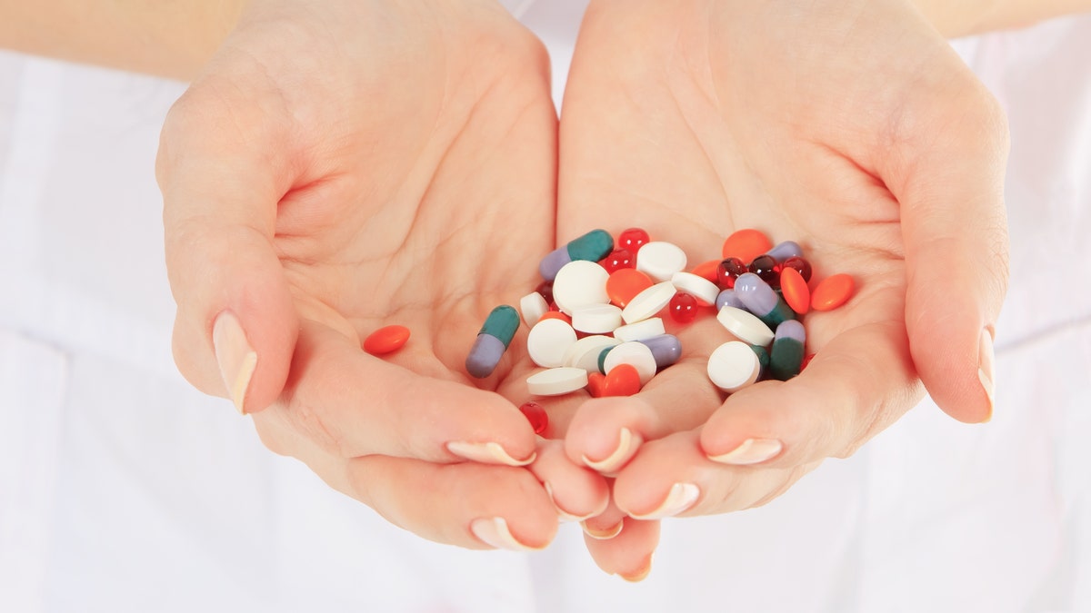 Close-up of doctor holding a pills in the hands