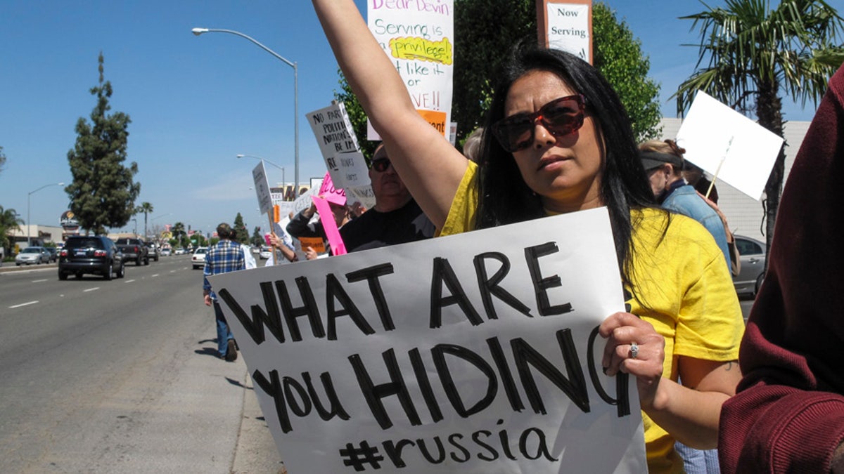 Katherine Cruz protests Rep. Devin Nunes, who visited Fresno, Calif., on Friday, March 31, 2017. Rep. Nunes, a Republican, is facing intense criticism as chair of the House Intelligence Committee for handling an investigation into Russian meddling of the 2016 presidential election. (AP Photo/Scott Smith)