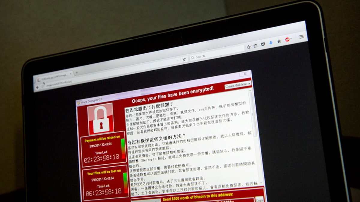 A screenshot of the warning screen from a purported ransomware attack, as captured by a computer user in Taiwan, is seen on laptop in Beijing, Saturday, May 13, 2017. Dozens of countries were hit with a huge cyberextortion attack Friday that locked up computers and held users' files for ransom at a multitude of hospitals, companies and government agencies. (AP Photo/Mark Schiefelbein)