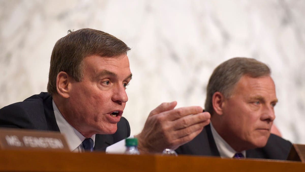 Senate Intelligence Committee Vice Chairman Sen. Mark Warner, D-Va., left, sitting next to Chairman Sen. Richard Burr, R-N.C., right, asks a question during a hearing about the Foreign Intelligence Surveillance Act, on Capitol Hill in Washington, Wednesday, June 7, 2017. (AP Photo/Susan Walsh)