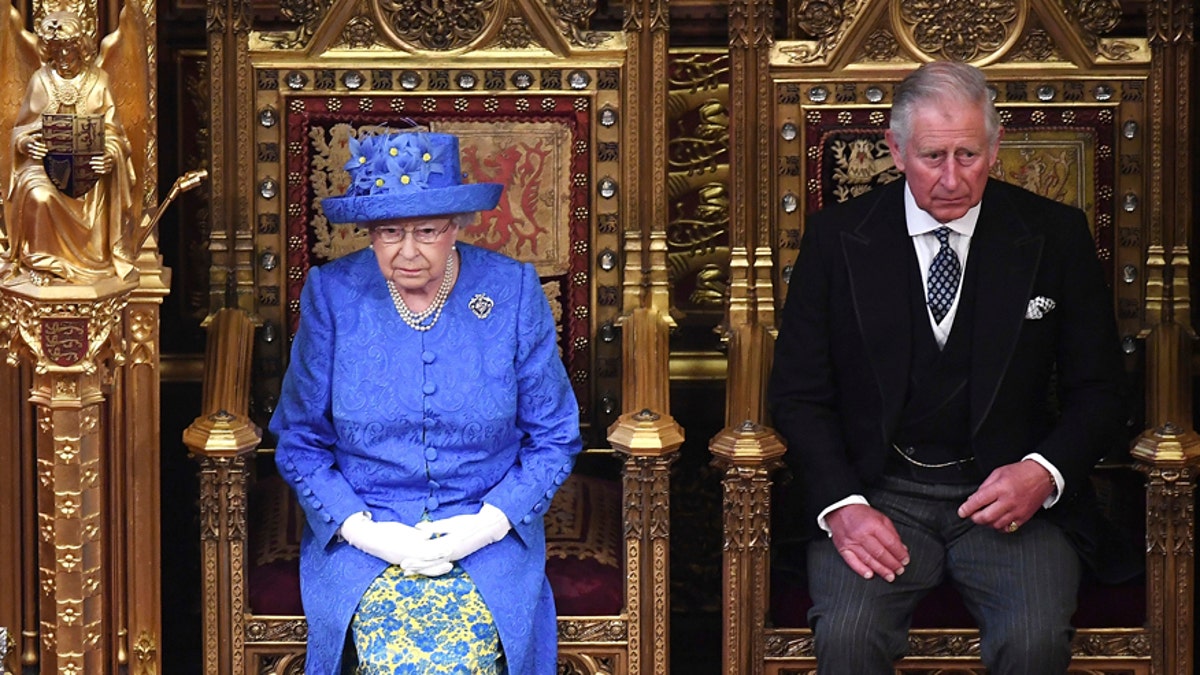 Britain's Queen Elizabeth II and Prince Charles sit in the House of Lords at the official State Opening of Parliament in London, Wednesday, June 21, 2017. Queen Elizabeth II goes to parliament Wednesday to outline the government's legislative program with far less pageantry than usual in a speech expected to be dominated by Britain's plans for leaving the European Union. (Carl Court/Pool via AP)