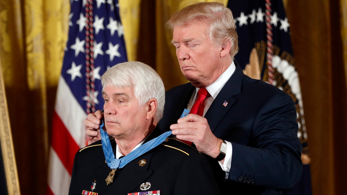 President Donald Trump bestows the nation's highest military honor, the Medal of Honor to retired Army medic James McCloughan during a ceremony in the East Room of the White House in Washington, Monday, July 31, 2017. McCloughan is credited with saving the lives of members of his platoon nearly 50 years ago in the Battle of Nui Yon Hill in Vietnam. (AP Photo/Pablo Martinez Monsivais)