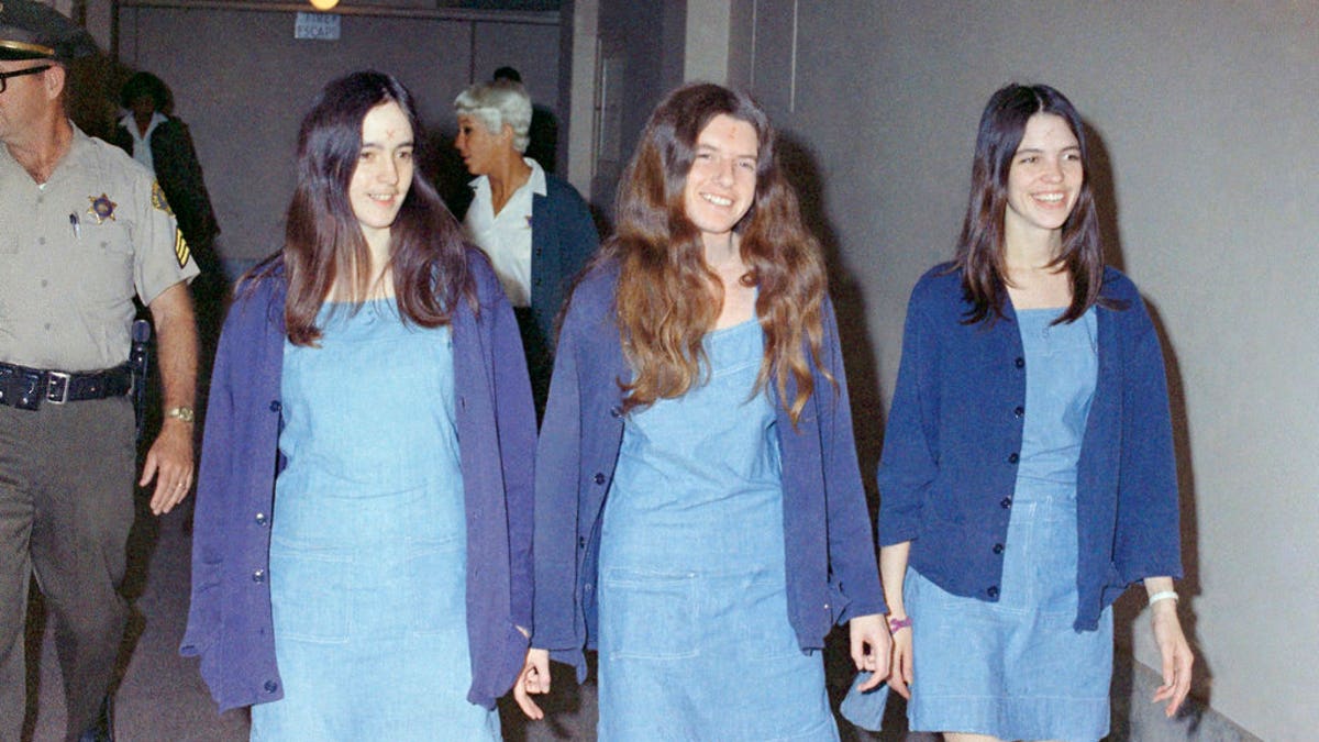 FILE - In this Aug. 20, 1970 file photo, Charles Manson followers, from left: Susan Atkins, Patricia Krenwinkel and Leslie Van Houten, walk to court to appear for their roles in the 1969 cult killings of seven people, including pregnant actress Sharon Tate, in Los Angeles, Calif. Van Houten is expected to get a court hearing Thursday, Aug. 31, 2017, to evaluate the role of her young age in the killing of a California couple four decades ago.(AP Photo/George Brich, File)