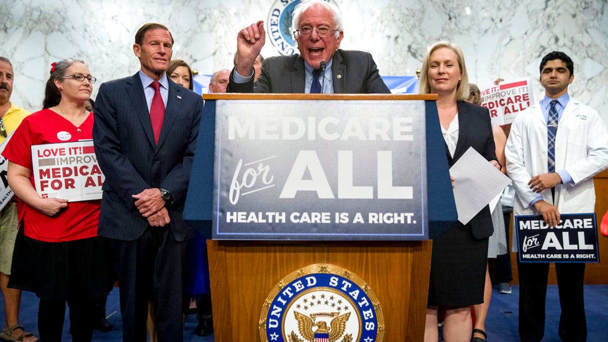 Sen. Bernie Sanders, I-Vt., center, joined by Sen. Richard Blumenthal, D-Conn., center left, Sen. Kirsten Gillibrand, D-N.Y., center right, and supporters, speaks at a news conference on Capitol Hill in Washington, Wednesday, Sept. 13, 2017, to unveil their Medicare for All legislation to reform health care. (AP Photo/Andrew Harnik)