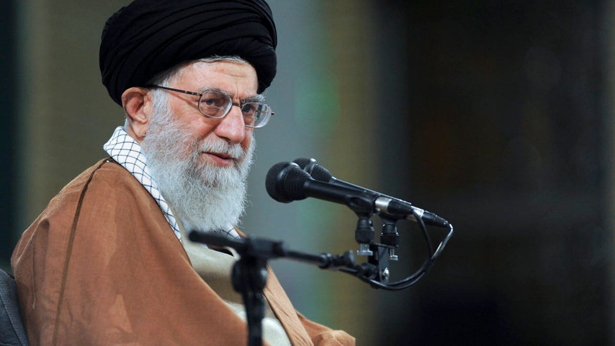Ayatollah Ali Khamenei with mic at an event