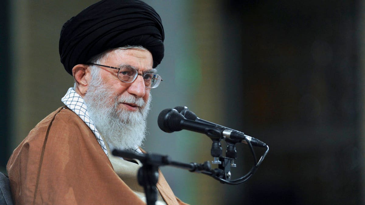 Ayatollah Ali Khamenei with mic at an event