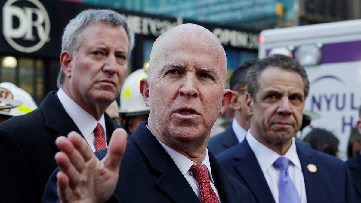 New York City Police Commissioner James O'Neill holds a news conference outside the Port Authority Bus Terminal with Mayor Bill de Blasio, left, and Gov. Andrew Cuomo, Monday, Dec. 11, 2017, in New York. Police said a pipe bomb strapped to a man went off in a crowded subway corridor near Times Square. (AP Photo/Mark Lennihan)