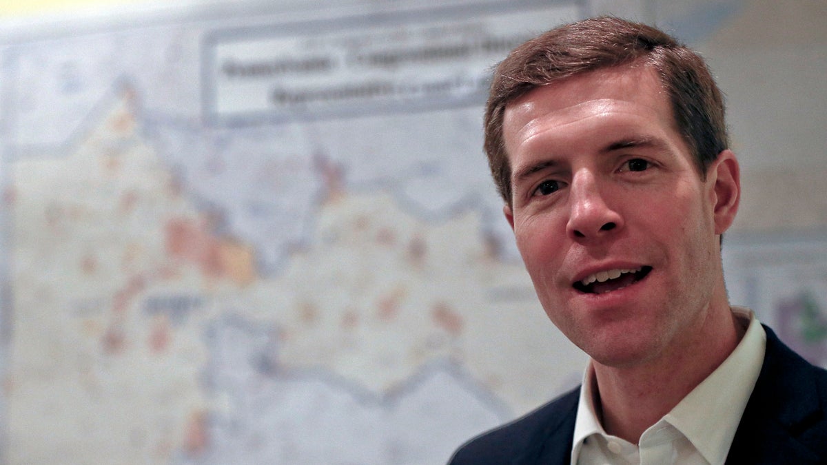 Democrat Conor Lamb, stands in front of the map of the congressional district he is running to represent while at a campaign office, Wednesday, March 7, 2018 in Carnegie, Pa. Lamb is running against Republican Rick Saccone in a special election being held on March 13 for the PA 18th Congressional District vacated by Republican Tim Murphy. (AP Photo/Keith Srakocic)