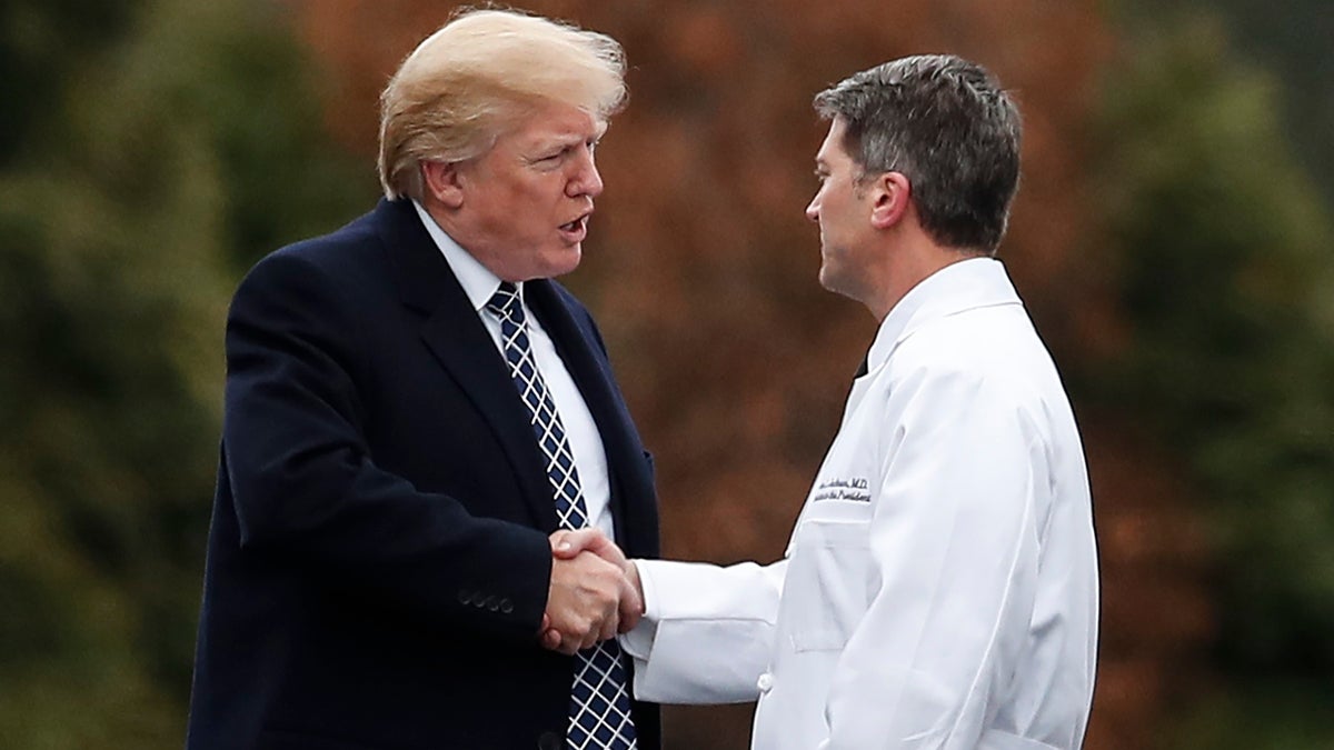 FILE - In this Friday, Jan. 12, 2018 file photo, President Donald Trump shakes hands with White House physician Dr. Ronny Jackson as he boards Marine One to leave Walter Reed National Military Medical Center in Bethesda, Md., after his first medical check-up as president. On Wednesday, March 28, 2018, President Donald Trump fired Veterans Affairs Secretary David Shulkin, and tweeted that Jackson is his nominee to replace Shulkin. (AP Photo/Carolyn Kaster)